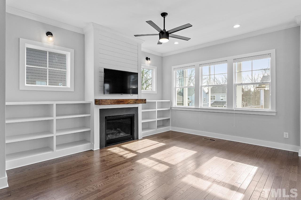 2320.5 Milburnie Road Raleigh, NC 27610 - Photo 10 of 32 a living room with fireplace cabinet and flat screen tv