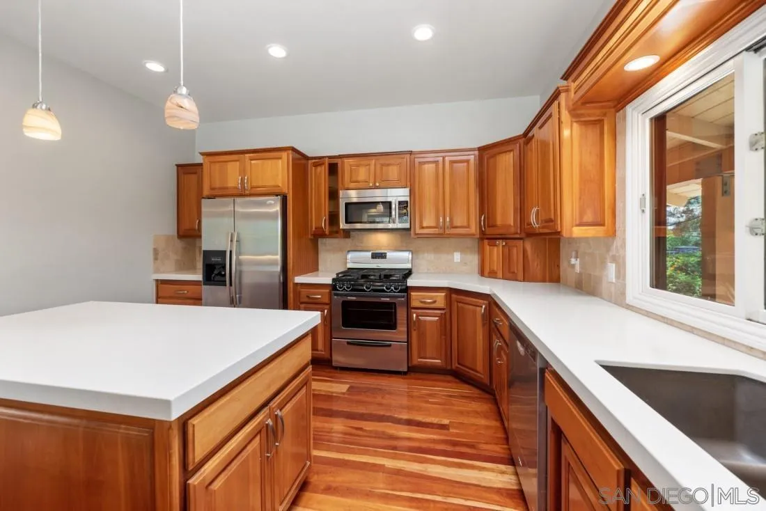 13260 Glen Circle Road Poway, CA 92064 - Photo 15 of 53 a kitchen with a stove a sink and a refrigerator