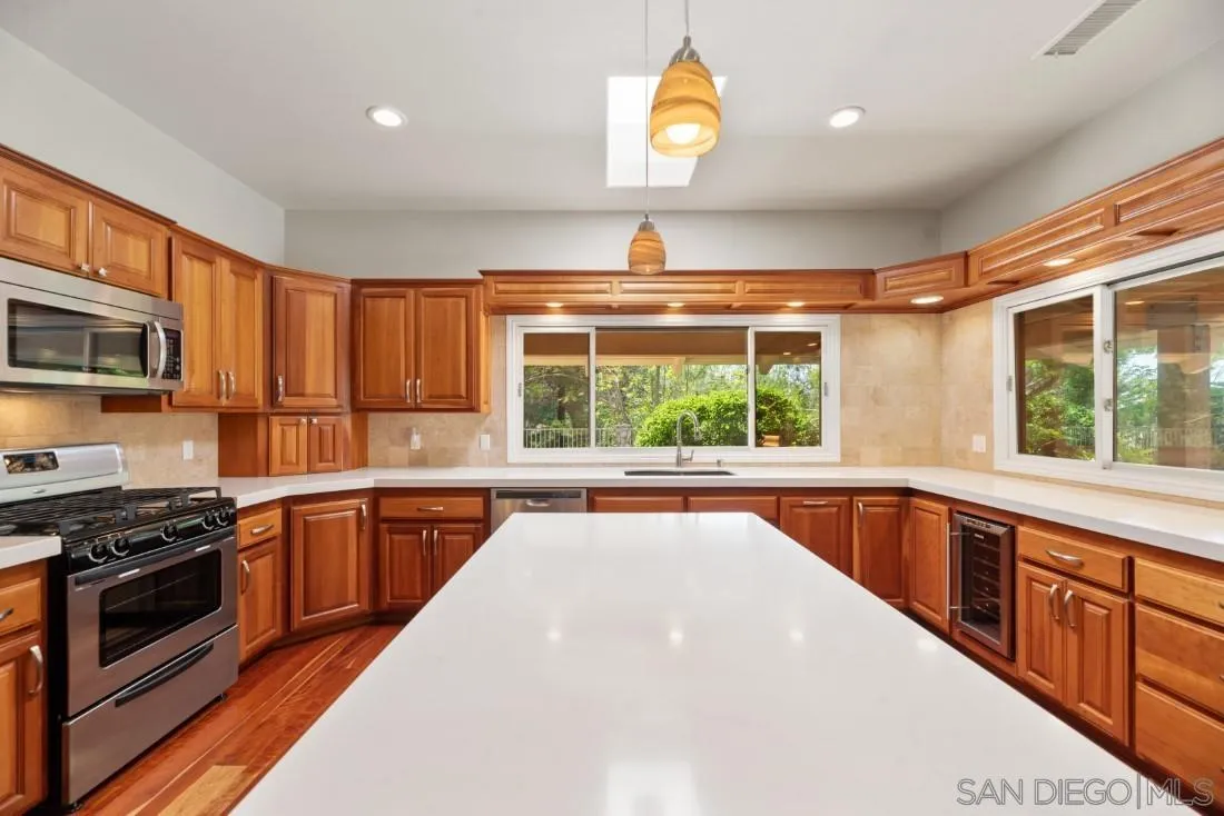 13260 Glen Circle Road Poway, CA 92064 - Photo 16 of 53 a large kitchen with stainless steel appliances granite countertop a stove and a sink