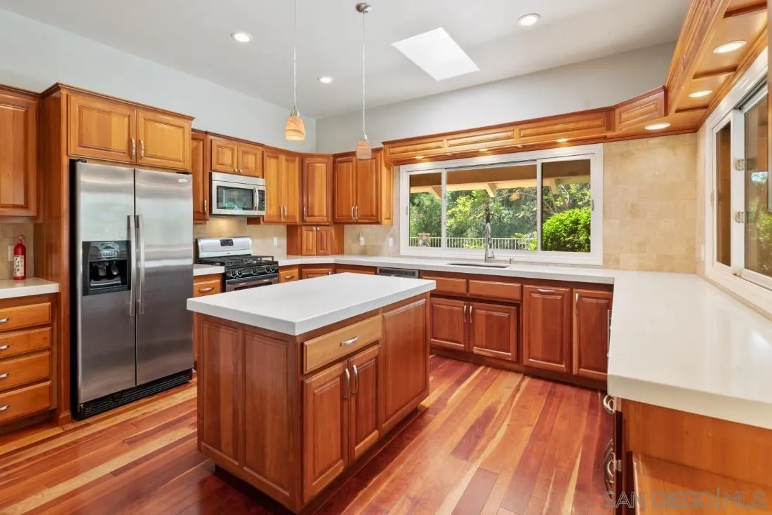 13260 Glen Circle Road Poway, CA 92064 - Photo 3 of 53 a kitchen that has a lot of cabinets in it and wooden floors