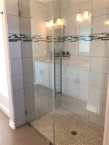 a bathroom with a glass shower door