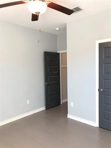 a view of an empty room with a cabinet
