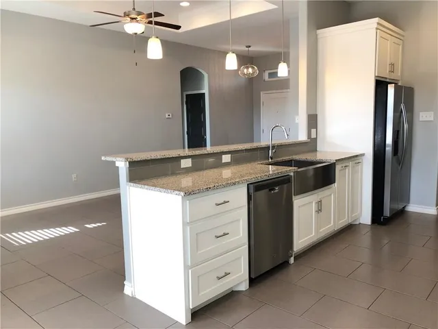 a bathroom with a granite countertop sink a large mirror and a shower
