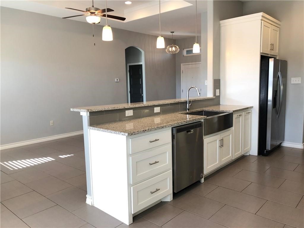 14834 Aquarius Street Corpus Christi, TX 78418 - Photo 6 of 34 a bathroom with a granite countertop sink a large mirror and a shower