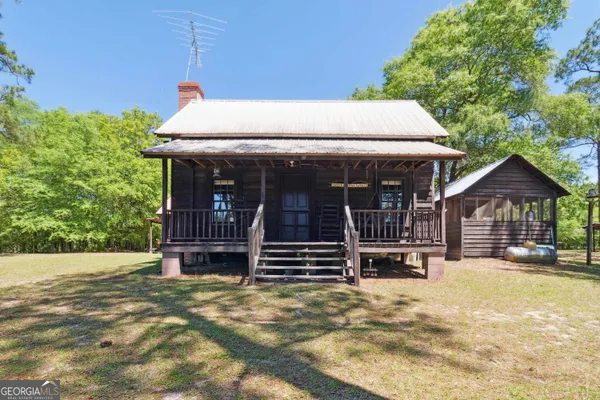 a view of house with wooden floor and outdoor seating