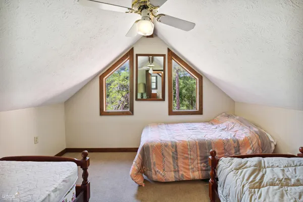 a bedroom with two beds and a window
