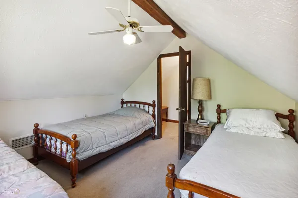 a bed room with a bed lamp and a potted plant