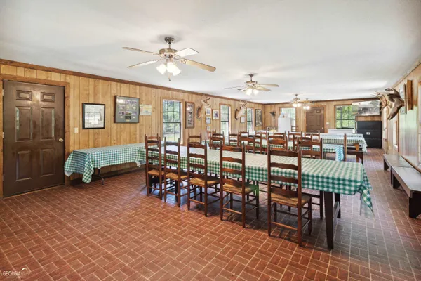 a dining room with furniture and wooden floor