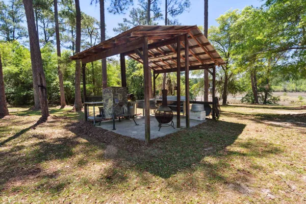 a view of a patio with table and chairs under an umbrella