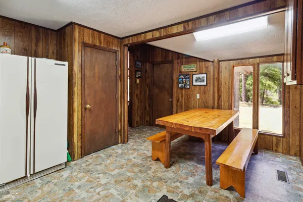 a room with pool table and windows