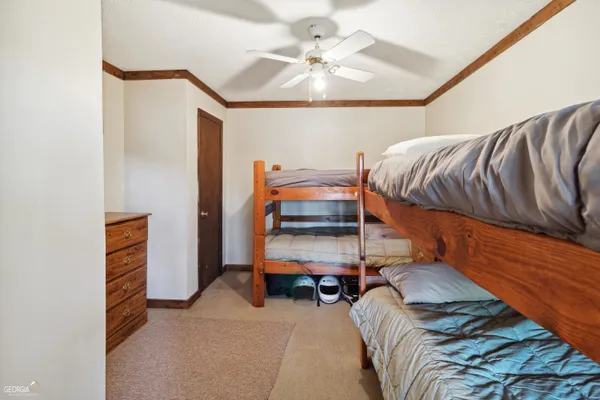 a bedroom with a bunk bed and a chandelier