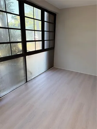 a view of an empty room with a window