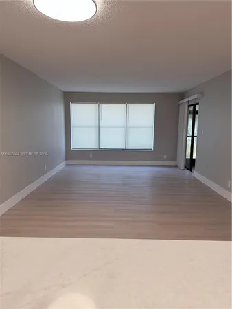 a view of wooden floor and windows in a room