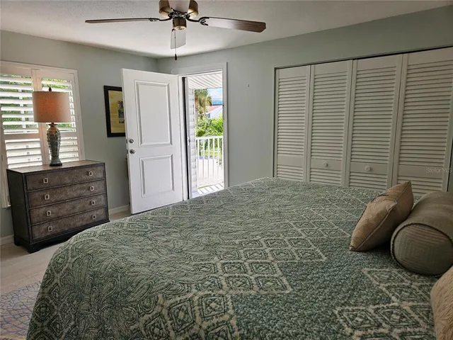 a view of a balcony and a floor to ceiling window next to a yard