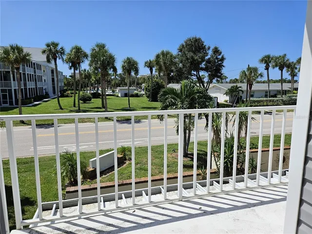 a view of a balcony with wooden fence