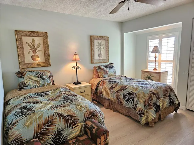 a bedroom with a bed and flat screen tv