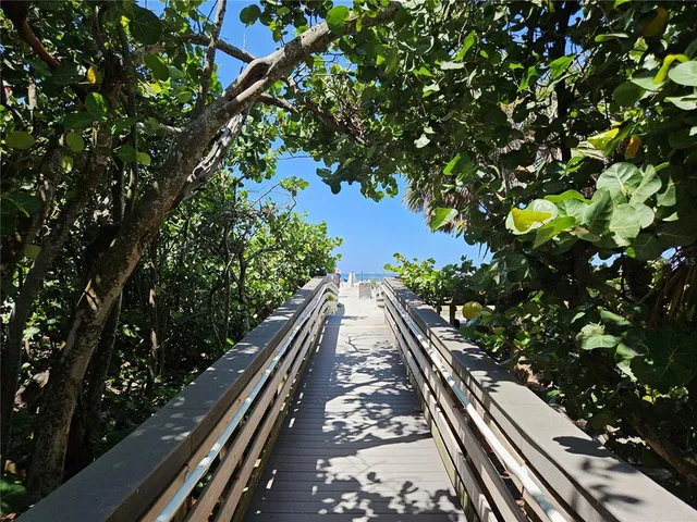 a view of a balcony with wooden floor and outdoor space
