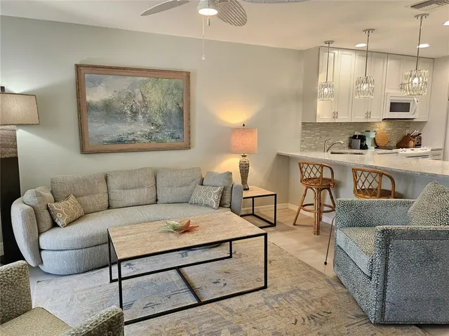 a living room with furniture and a lamp