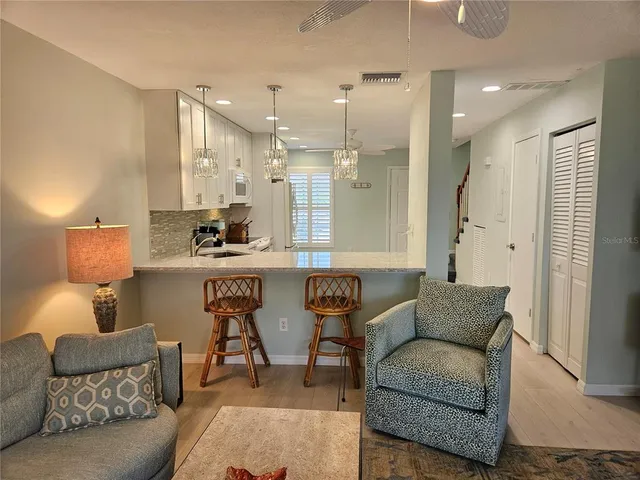 a living room with furniture and a lamp