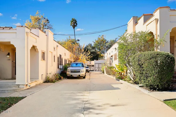 a view of a patio with table and chairs potted plants