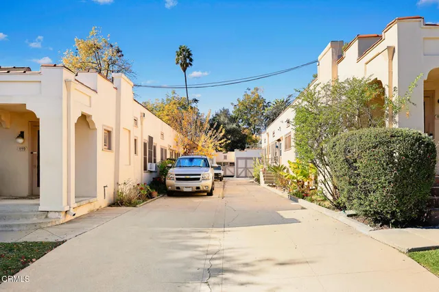 a view of a patio with table and chairs potted plants