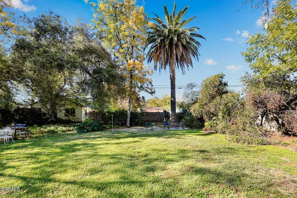 a view of a house with a yard and sitting area