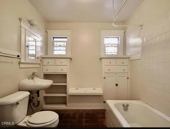 a view of cabinets a wooden floor and a window