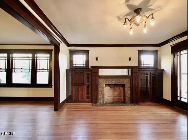a view of cabinets a wooden floor and a window