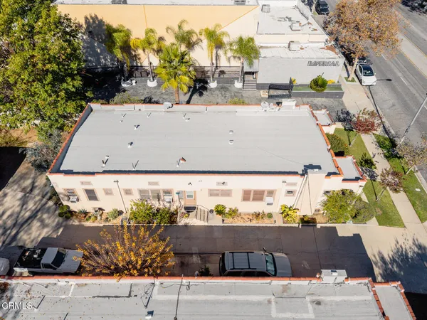 front view of a house with a yard and sitting area