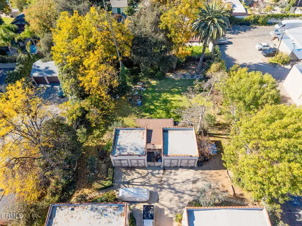 an aerial view of residential houses with outdoor space