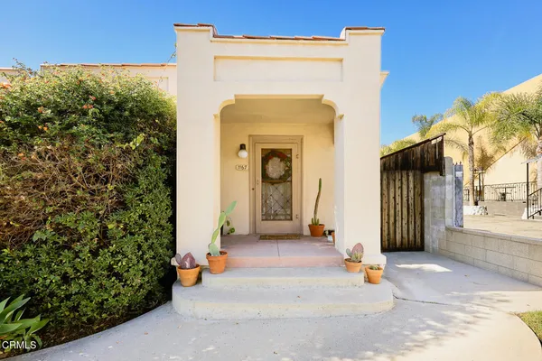 a view of a house with palm trees