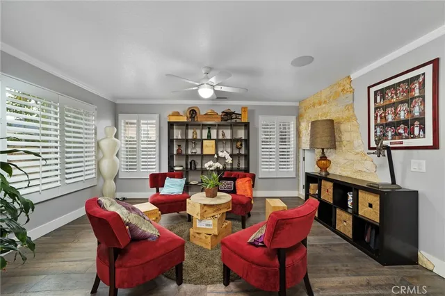 a living room with furniture a flat screen tv and a window