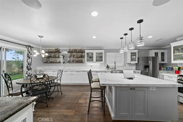 a view of a dining room with furniture and chandelier