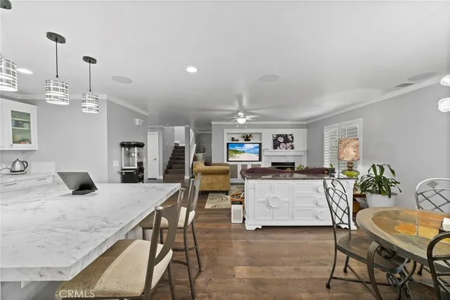 a living room with furniture and view of kitchen