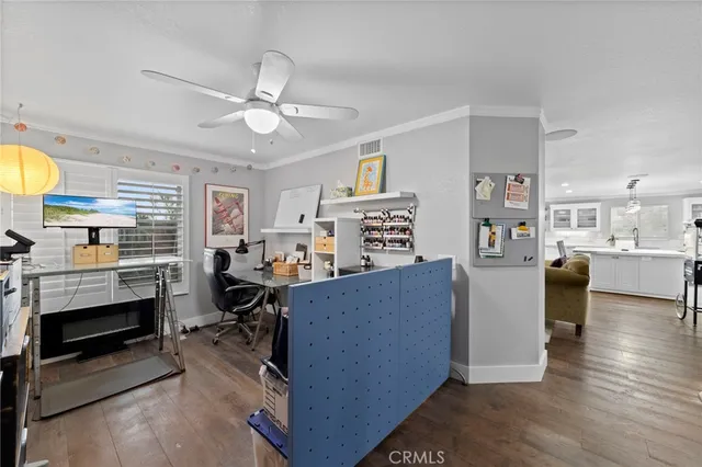 a living room with furniture and a kitchen