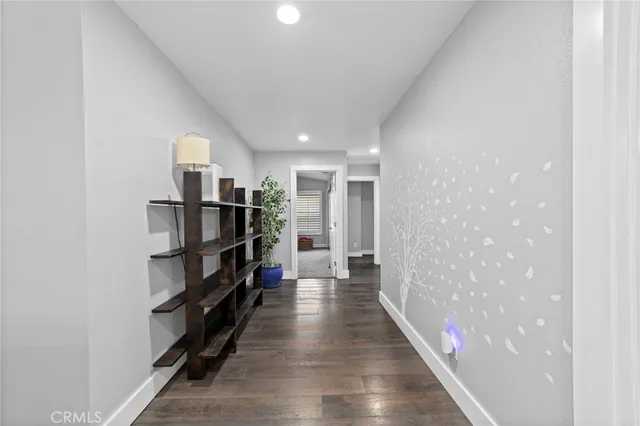 a view of empty room with wooden floor and window