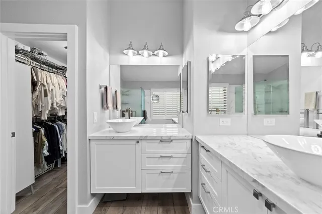 a spacious bathroom with a granite countertop sink and a mirror