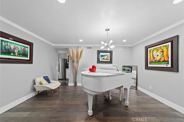 a living room with furniture and a dining table with wooden floor