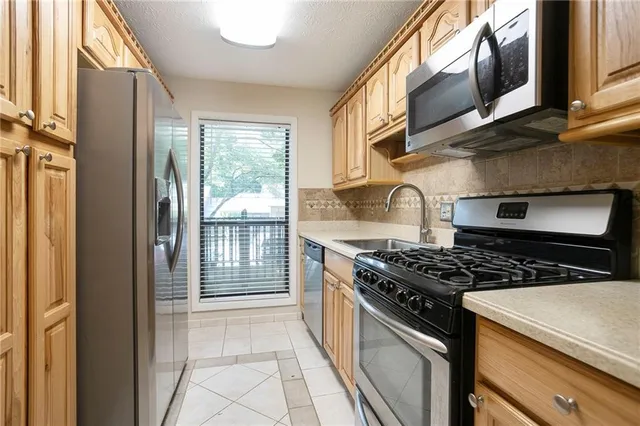 a kitchen with stainless steel appliances granite countertop a stove and a refrigerator