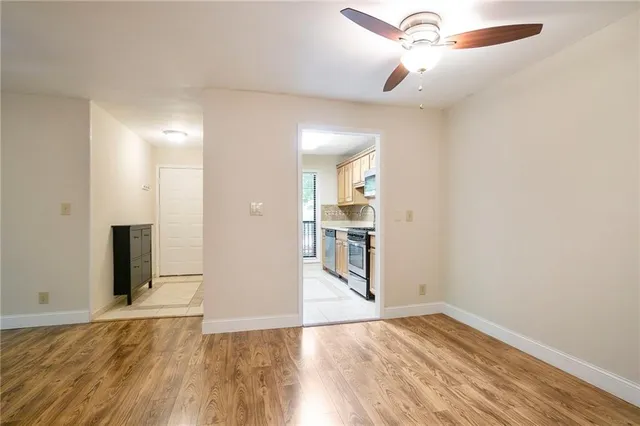a view of empty room with wooden floor