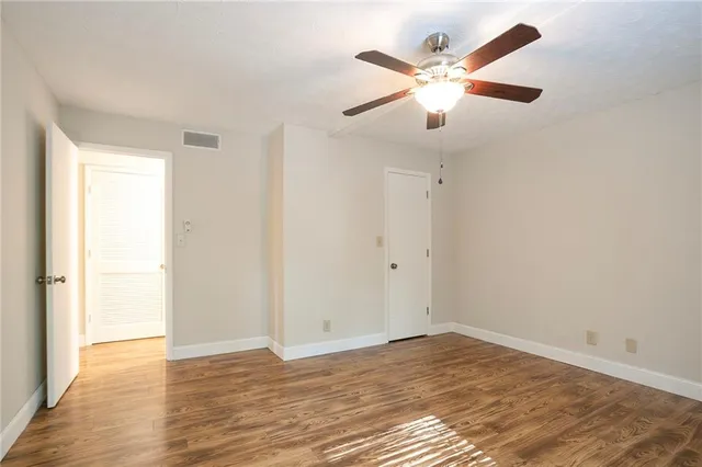 a view of an empty room with wooden floor