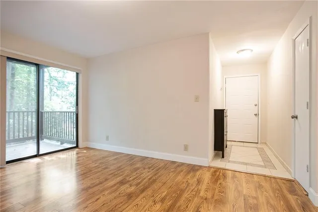 wooden floor in an empty room with a window