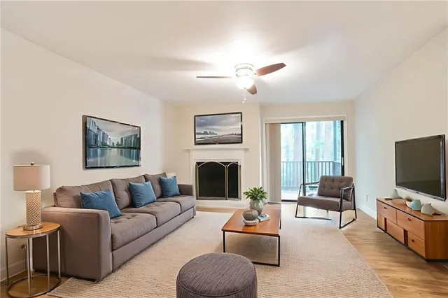 a living room with furniture a fireplace and a flat screen tv