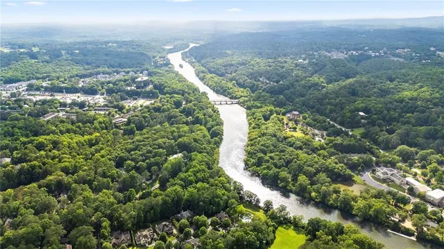 a view of a city with lush green forest