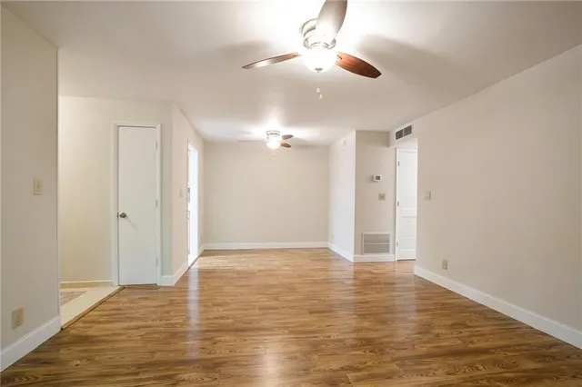 a view of an empty room and wooden floor