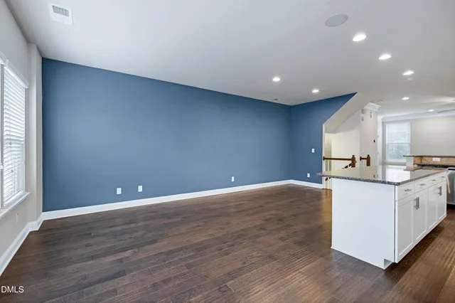 a bathroom with a granite countertop sink mirror and a shower