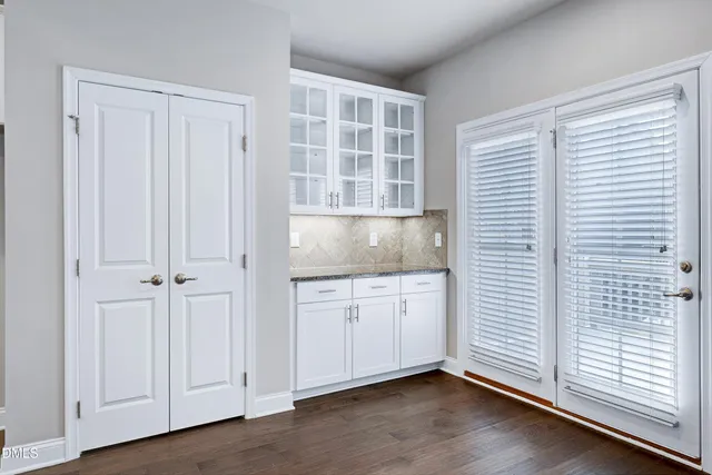 a bathroom with a granite countertop sink mirror vanity and toilet