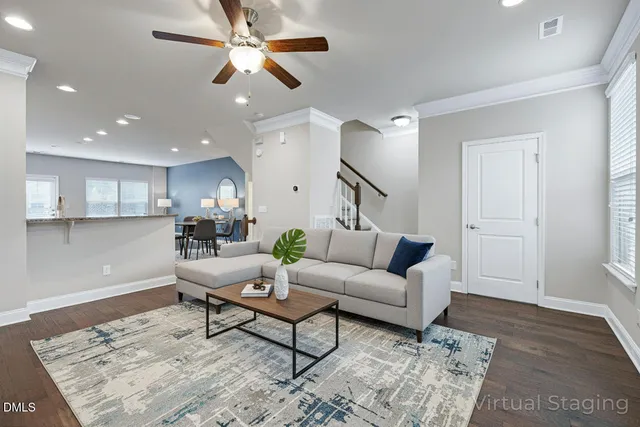 a living room with furniture and wooden floor