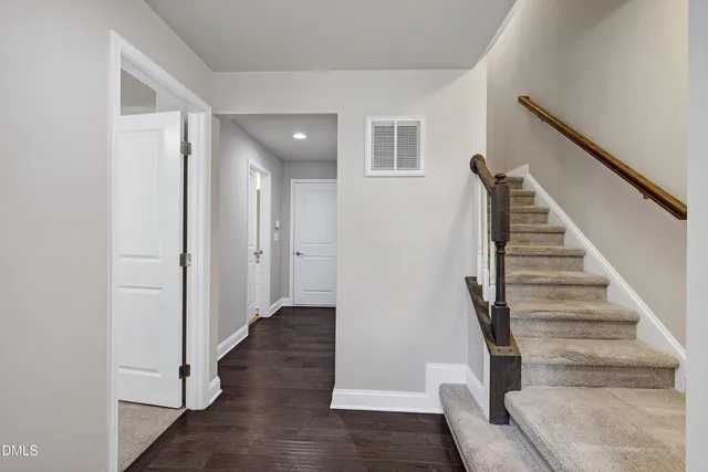 a view of a balcony with two chairs and wooden floor