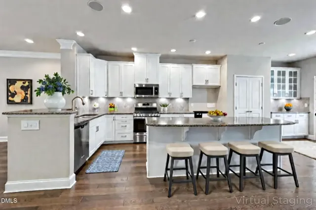 a large kitchen with stainless steel appliances granite countertop a stove a sink and a refrigerator
